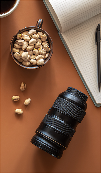 Our Mission - Creator workspace with coffee, camera lens, and creative tools